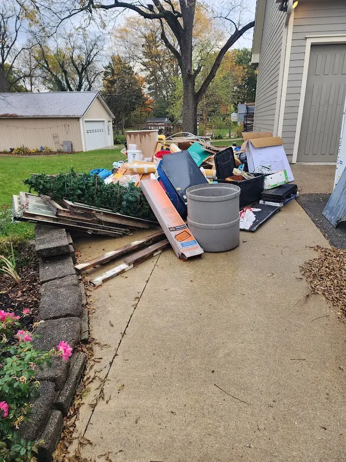Dumpster being loaded with debris for Commercial Dumpster Rental in Laurel